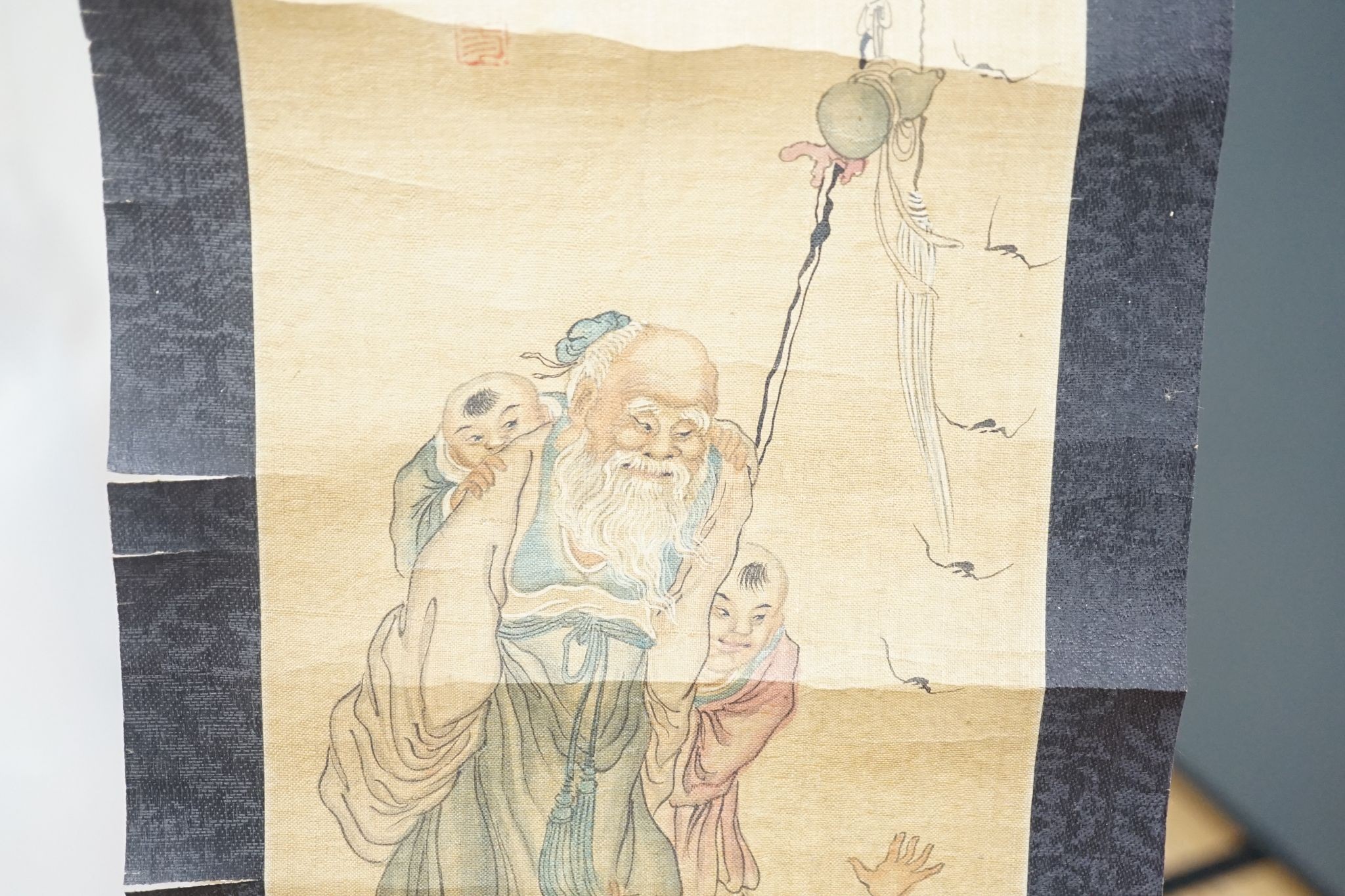 A late 19th century hand scroll and three other scroll paintings